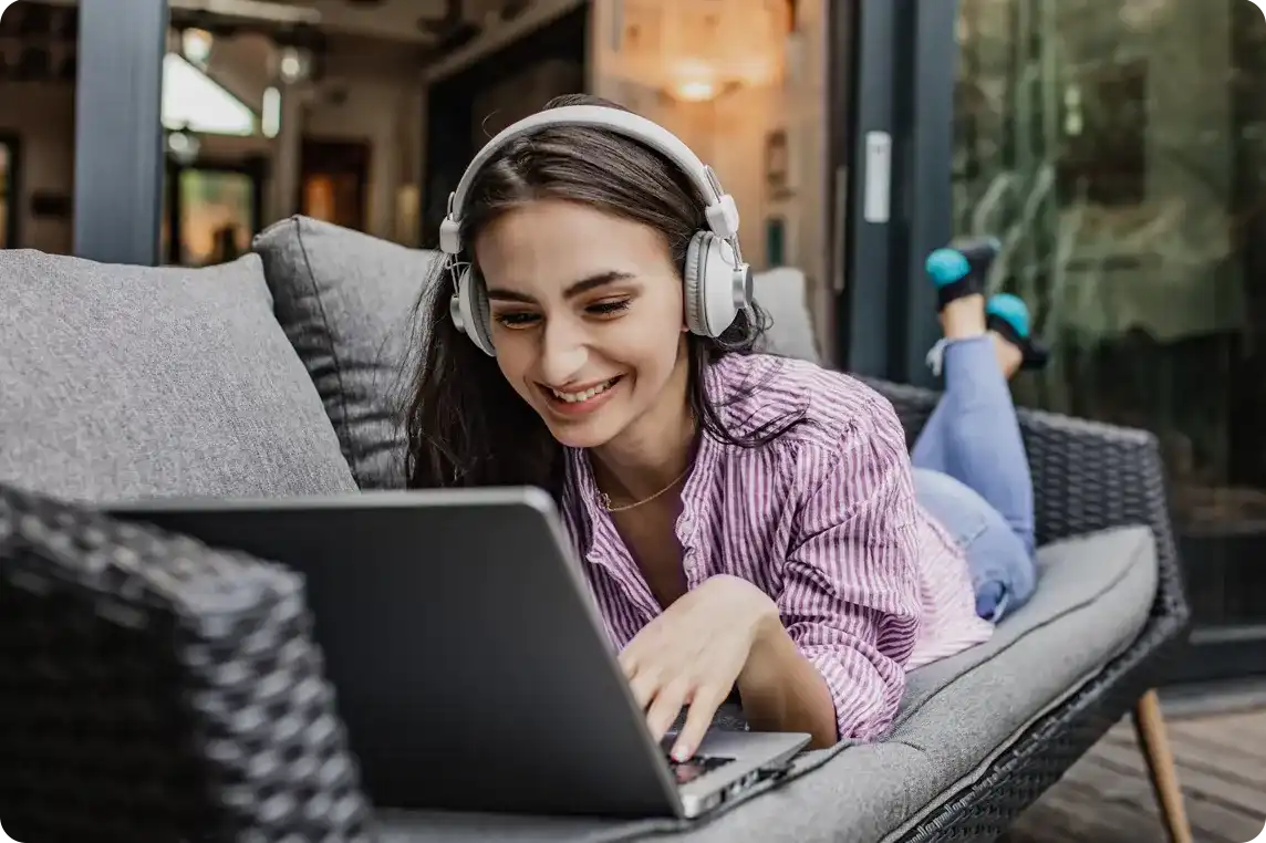 girl using laptop on lounger