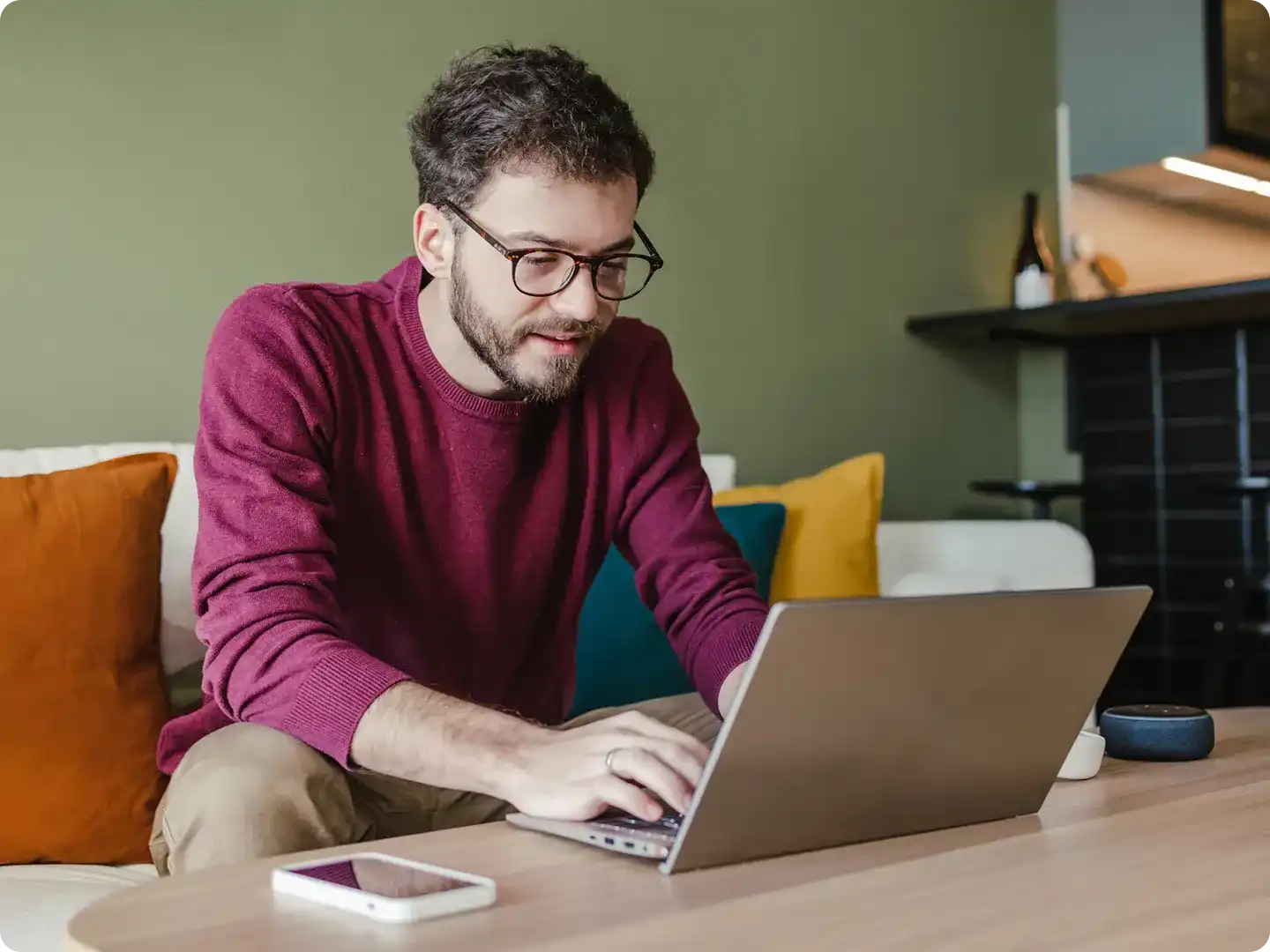 man using his laptop at a coffee table
